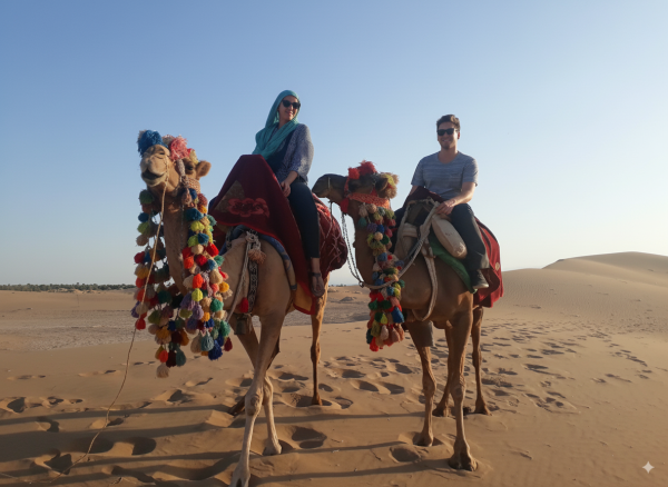Tourists riding camels across golden dunes in Bafgh Desert, Yazd Province, Iran desert