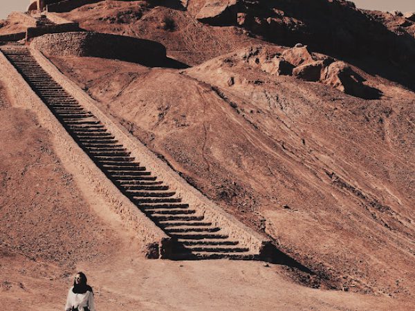 Visitors walking near the circular Zoroastrian Tower of Silence on the outskirts of Yazd | Iran&rsquo;s Travel
