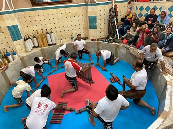 Tourists watching a traditional strength and ritual performance in a Yazd Zoorkhaneh | Iran&rsquo;s Travel