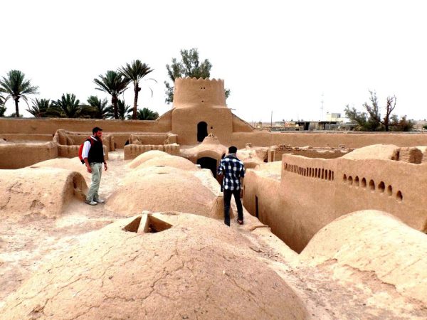Tourists walking on the rooftop of historic Ariz Castle in Bafgh, Yazd Province, with desert views | Iran&rsquo;s Travel